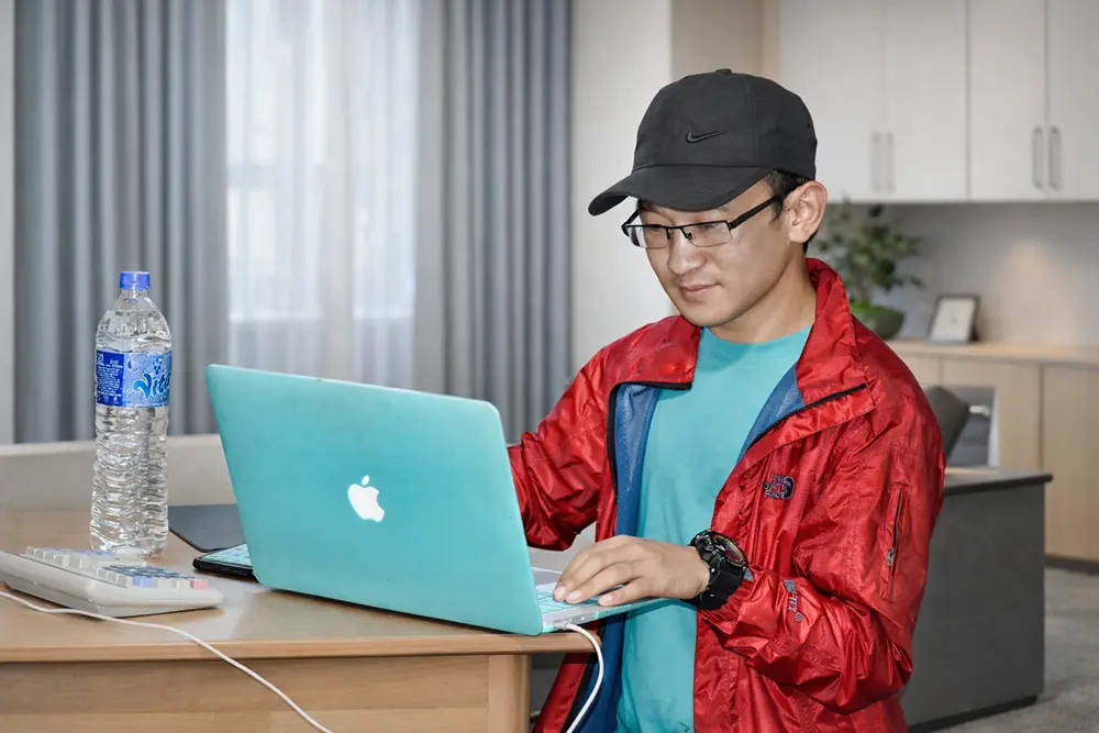 Labun Hang Limboo, WordPress developer, Website Developer, and SEO content specialist working on a laptop in a workspace